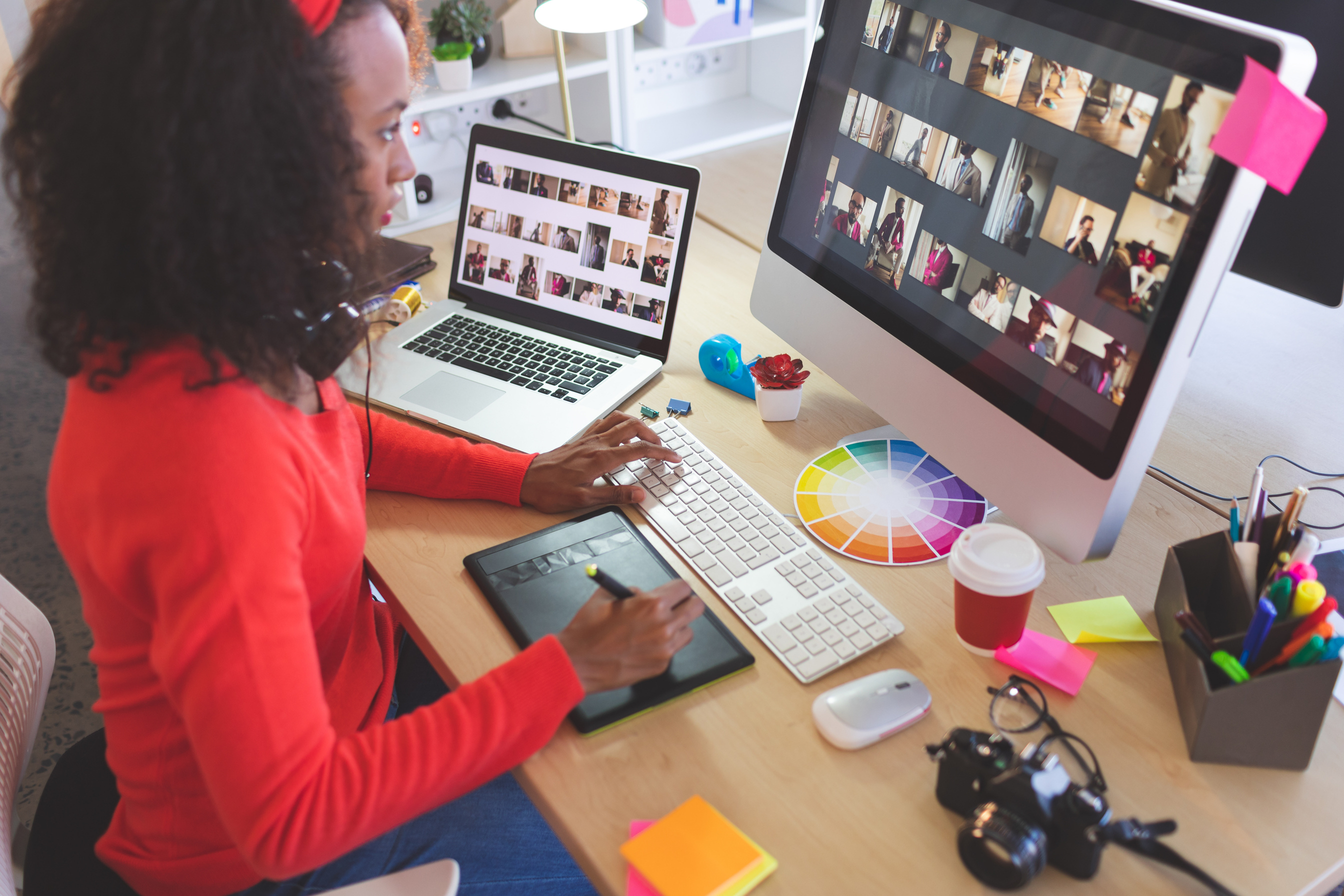 Female graphic designer using graphic tablet at desk